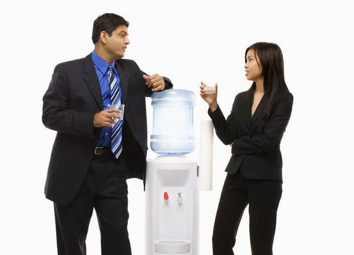 Image of two business people at a water cooler